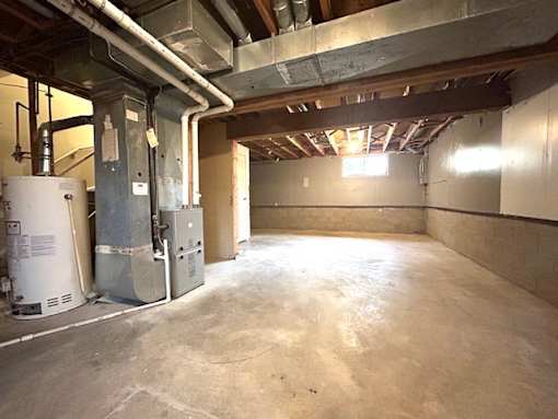 a large room with a concrete floor and pipes in it