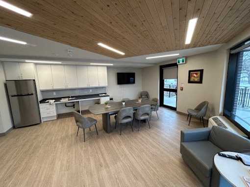 A modern kitchen with a dining table and chairs.
