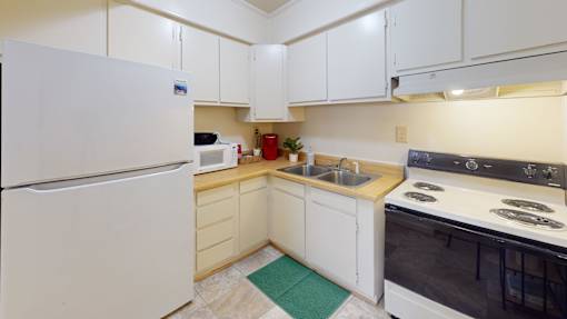 a full-size kitchen with a refrigerator