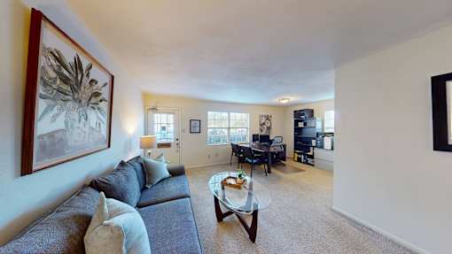 A living room with a couch, coffee table, and television.