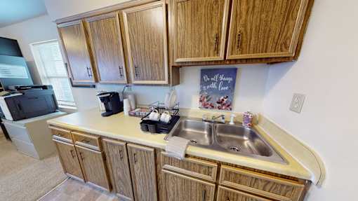A kitchen with wooden cabinets and a sink.