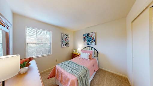 a bedroom with a window and walk-in closet