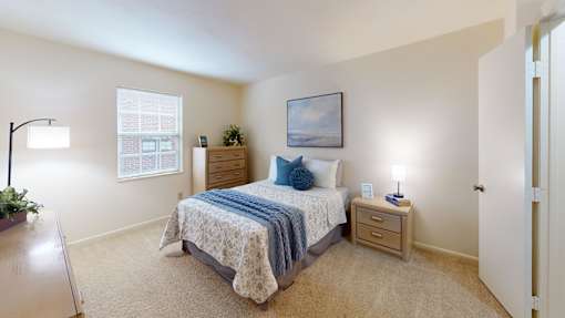 a bedroom with a window and walk-in closet