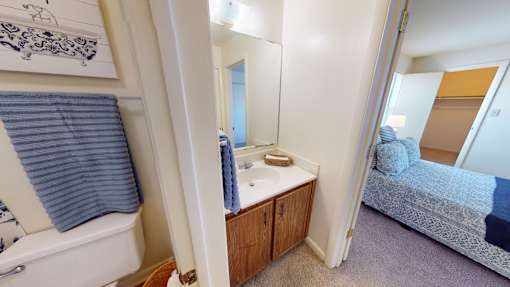 A bathroom with a white tub and a blue towel.