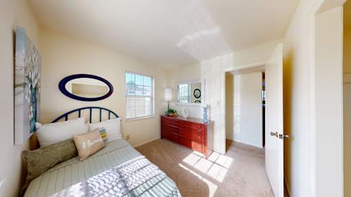 a bedroom with a window and walk-in closet
