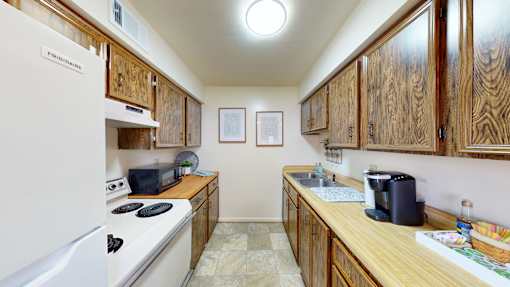 a kitchen with wooden cabinets and a refrigerator