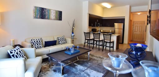 a living room with a couch and a table and a kitchen