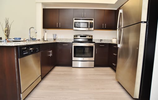 a kitchen with stainless steel appliances and wooden cabinets