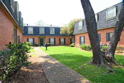 A brick building with a green lawn in front.