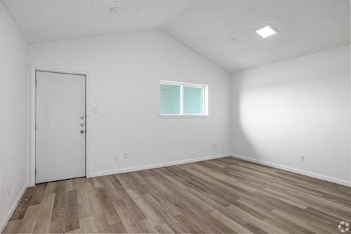 A room with a white door and a window with white frame.