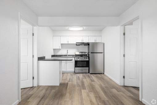 A kitchen with white cabinets and stainless steel appliances.