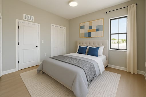 A bedroom with a large bed and a window.