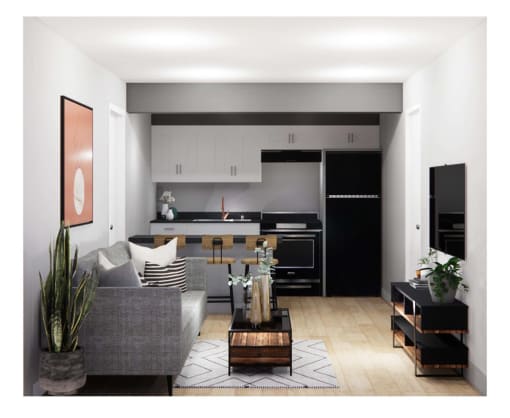 a black and white living room with a kitchen in the background