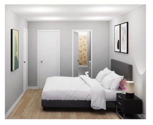 a bedroom with a white bed and a white door