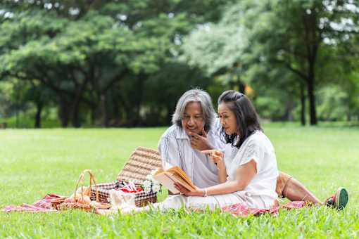 A couple is having a picnic in a park.