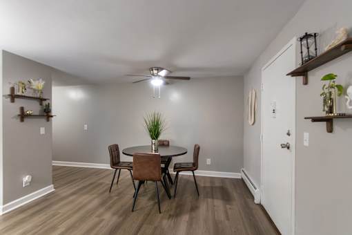 A dining room with a table and chairs in a 1 bedroom, 1 bath 560 square foot apartment at Aspen Village Apartments in the Westwood neighborhood of Cincinnati, OH.