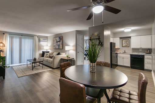 A modern dining room with a round table and chairs in a 1 bedroom, 1 bath 560 square foot apartment at Aspen Village Apartments in the Westwood neighborhood of Cincinnati, OH.