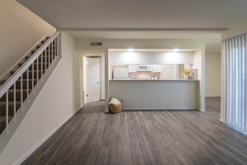 View of the kitchen from the living room in a 2 bedroom, 1.5 bath 1084 sq ft, 2-floor townhome at The Biltmore Apartments located in the Vickery Midtown neighborhood of Dallas, TX.