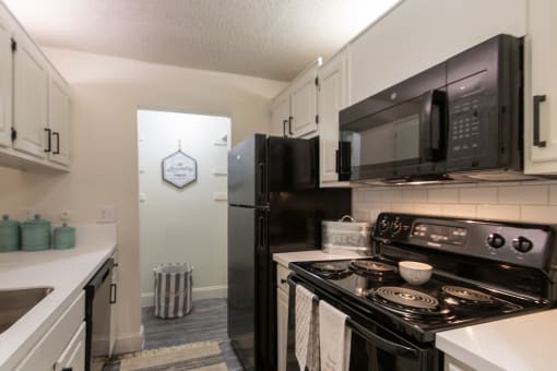 This is a photo of the kitchen in a 692 square foot 1 bed, 1 bath model aprtment at Cambridge Court Apartments in Dallas Texas