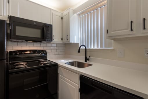 This is a photo of the kitchen in the 450 square foot efficiency apartment at Cambridge Court Apartments in Dallas, TX.