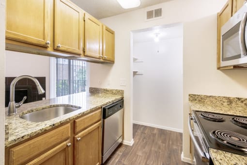 This is a photo of the kitchen in the 1245 square foot 2 bedroom, 2 bath apartment at Cambridge Court Apartments in Dallas, TX.