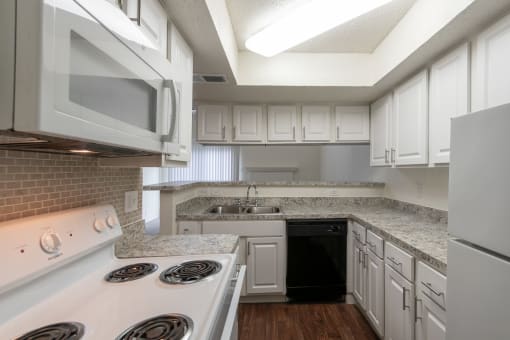 This is a photo of the kitchen in a 717 square foot 1 bedroom, 1 bath apartment at Canyon Creek Apartments in Dallas, TX