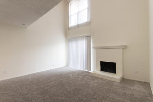 This is a photo of the living room with fireplace in a 717 square foot 1 bedroom, 1 bath apartment at Canyon Creek Apartments in Dallas, TX