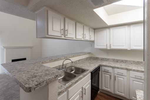 This is a photo of the kitchen  breakfast bar in a 717 square foot 1 bedroom, 1 bath apartment at Canyon Creek Apartments in Dallas, TX