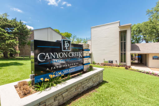 This is a photo of the entrance sign at Canyon Creek Apartments in Dallas, TX.