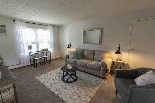 This is a photo of the living room in the 740 square foot 1 bedroom model apartment at Compton Lake Apartments in Mt. Healthy, OH.