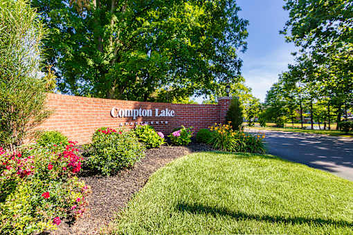 Community entrance/landscaping near the private stocked fishing pond at Compton Lake Apartments