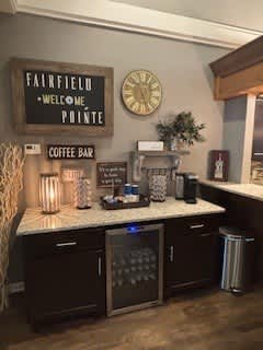 A coffee bar with a sign that says "Fairfield Welcome Pointe".