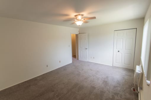This is a photo of the primary bedroom in the 1004 square foot, 2 bedroom townhome floor plan at Colonial Ridge Apartments in the Pleasant Ridge neighborhood of Cincinnati, OH.