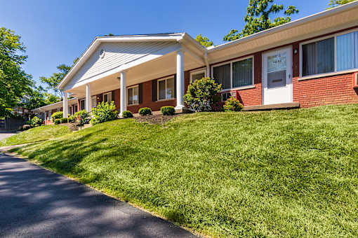 Single-story apartment homes with private entrances and covered front entries at Colonial Ridge Apartments