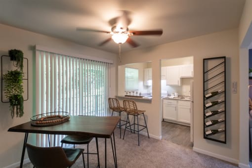 This is a photo of the kitchen from the dining room with pass through breakfast bar of the 550 square foot 1 bedroom, 1 bath, balcony floor plan model apartment at College Woods Apartments in thne NOrth College Hill neighborhood of Cincinnati, OH.