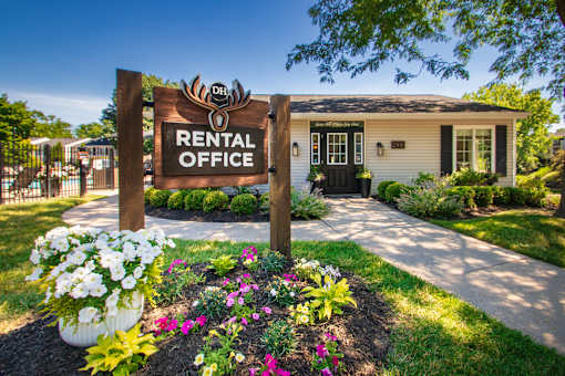 A rental office sign is in front of the leasing office Landscaped grounds next to the pool at Deer Hill Apartments in the Mount Washington neighborhood of Cincinnati, OH.