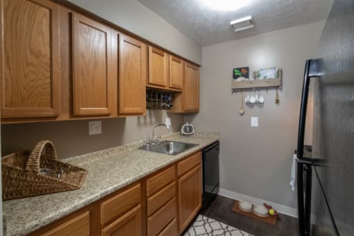 This is a photo of the kitchen in the upgraded 650 square foot, 1 bedroom, 1 bath model apartment at Deer Hill Apartments in Cincinnati, Ohio.