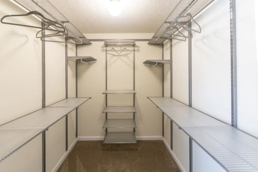 This is a photo of the bedroom walk-in closet with customizable closet system in the upgraded 650 square foot, 1 bedroom model apartment at Deer Hill Apartments in Cincinnati, Ohio.