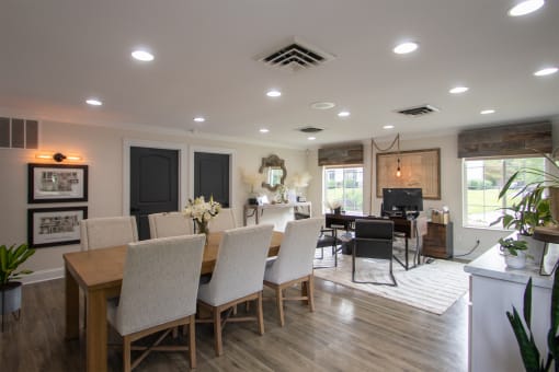 a dining room and living room with a table and chairs