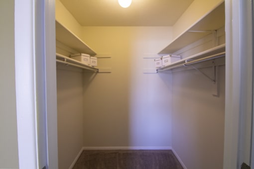 This is a photo of the primary bedroom walk-in closet in the 950 square foor, 2 bedroom apartment at Deer Hill Apartments in Cincinnati, OH.