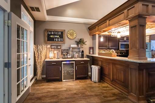 A coffee bar area with a sign that says "Fairfield Welcome Pointe".