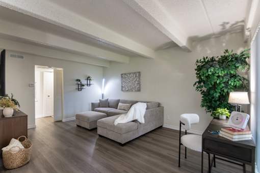 Open living room with neutral finishes and seating area in a 653-square-foot apartment home