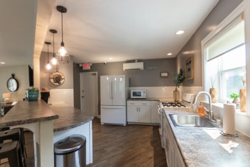 This is a photo of the kitchen in the resident clubhouse at Lake of the Woods Apartments in Cincinnati, OH.