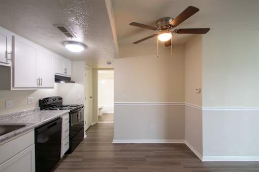 This is a photo of the kitchen and dining area with built-in bookshelf of the 560 square foot 1 bedroom, 1 bath Elm floor plan at Montana Valley Apartments in Cincinnati, OH.