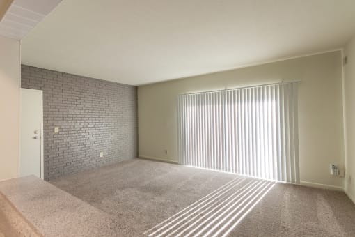 This is a photo the living room with painted brick accent wall of the 833 square foot Chestnut, 2 bedroom apartment at Montana Valley Apartments in Cincinnati, OH.