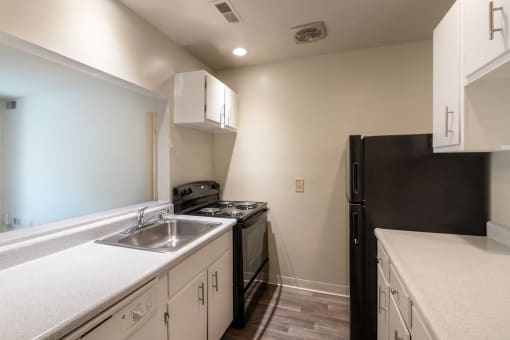 This is a photo the kitchen with white cabinets in the 925 square foot, Hazelnut 2 bedroom, 1 bath apartment at Montana Valley Apartments in the Westwood neighborhood of Cincinnati, OH.