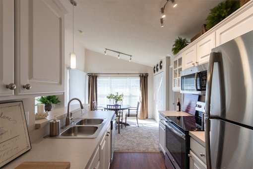 This is a photo of the dining area from the kitchen in the 1016 square foot, 2 bedroom, 2 bath Nautica floor plan at Nantucket Apartments in Loveland, OH.