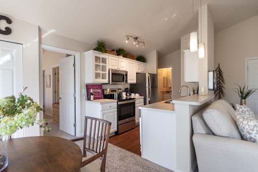 This is a photo of the kitchen from the dining area in the 1016 square foot, 2 bedroom, 2 bath Nautica floor plan at Nantucket Apartments in Loveland, OH.