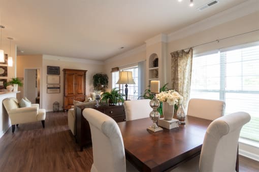 This is a photo of the dining area and living room in the 2 bedroom, 2 bath Islander floor plan at Nantucket Apartments in Loveland, OH.