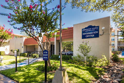 A sign for Princeton Court Information Center is displayed in front of the leasing office at Princeton Court Apartments in the Vickery Midtown neighborhood of Dallas, TX.